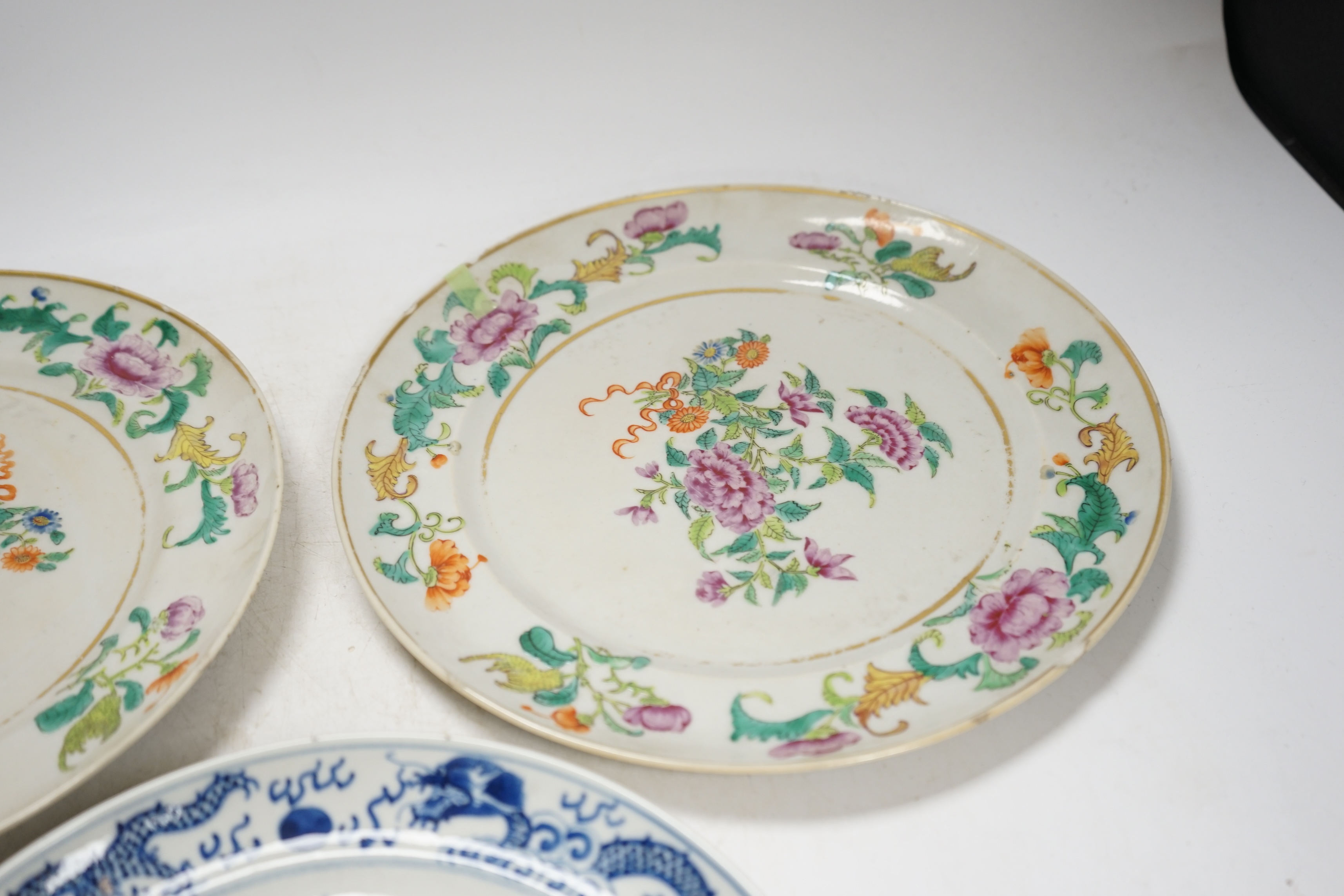 A pair of 19th century Chinese famille rose plates and another blue and white, largest 25cm diameter. Condition - blue and white good, others poor to fair